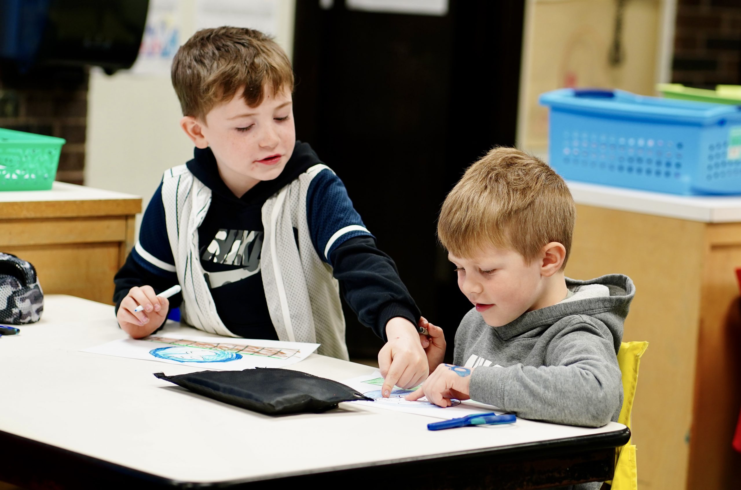 Boy with laptop sitting at desk