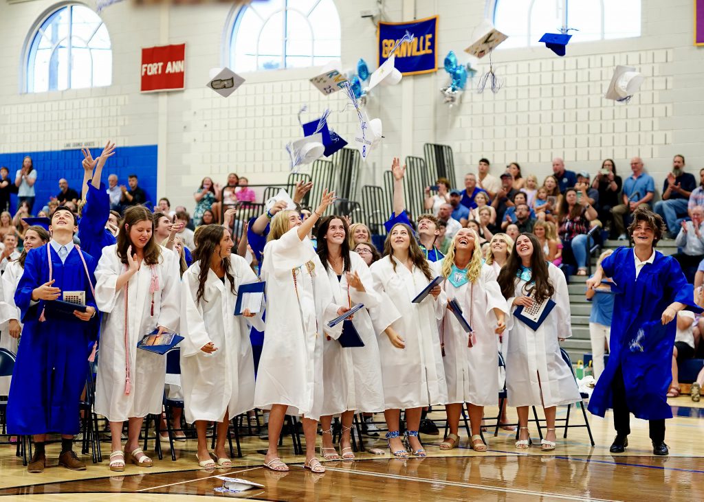 Students throwing caps at graduation
