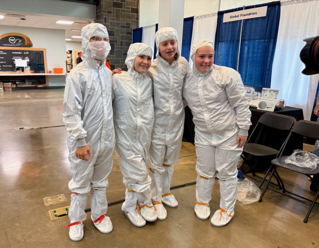 Four high school students in white surgical outfits