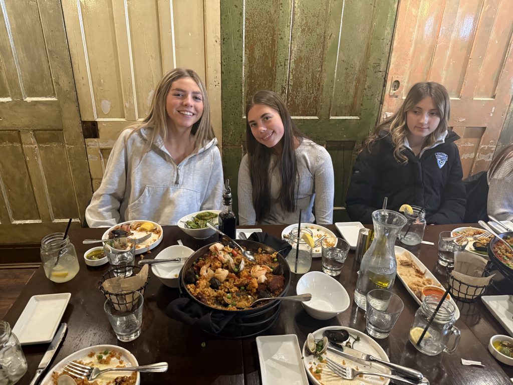 students sitting at a table in a restaurant