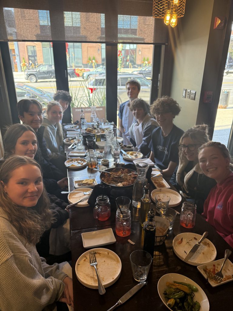 students sitting at a table in a restaurant