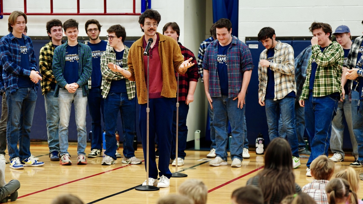 Boy with laptop sitting at desk