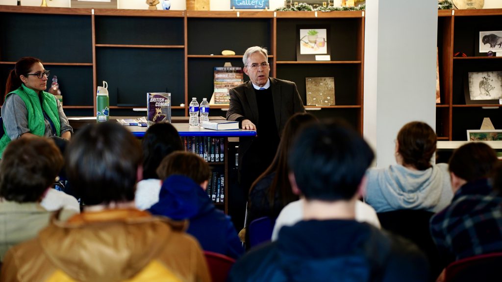 Author Rick Atkinson sits in front of a group of students