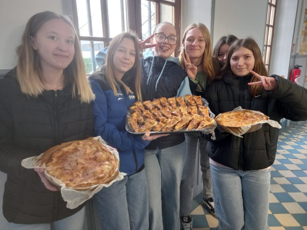 students holding homemade apple pies