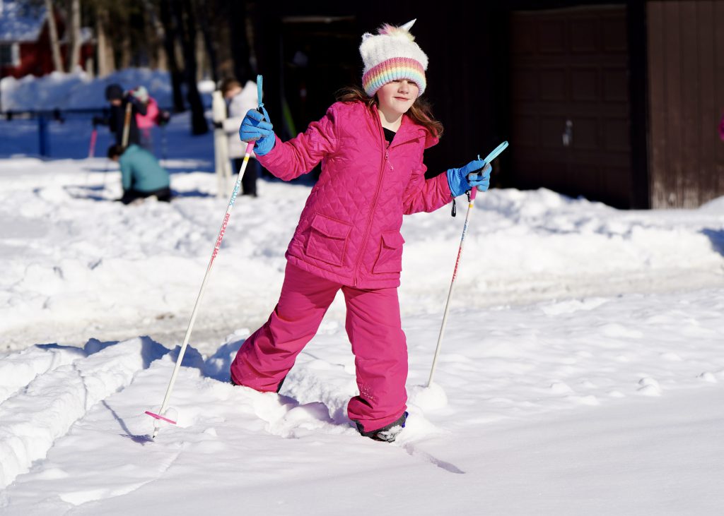 student cross-country skiing outside