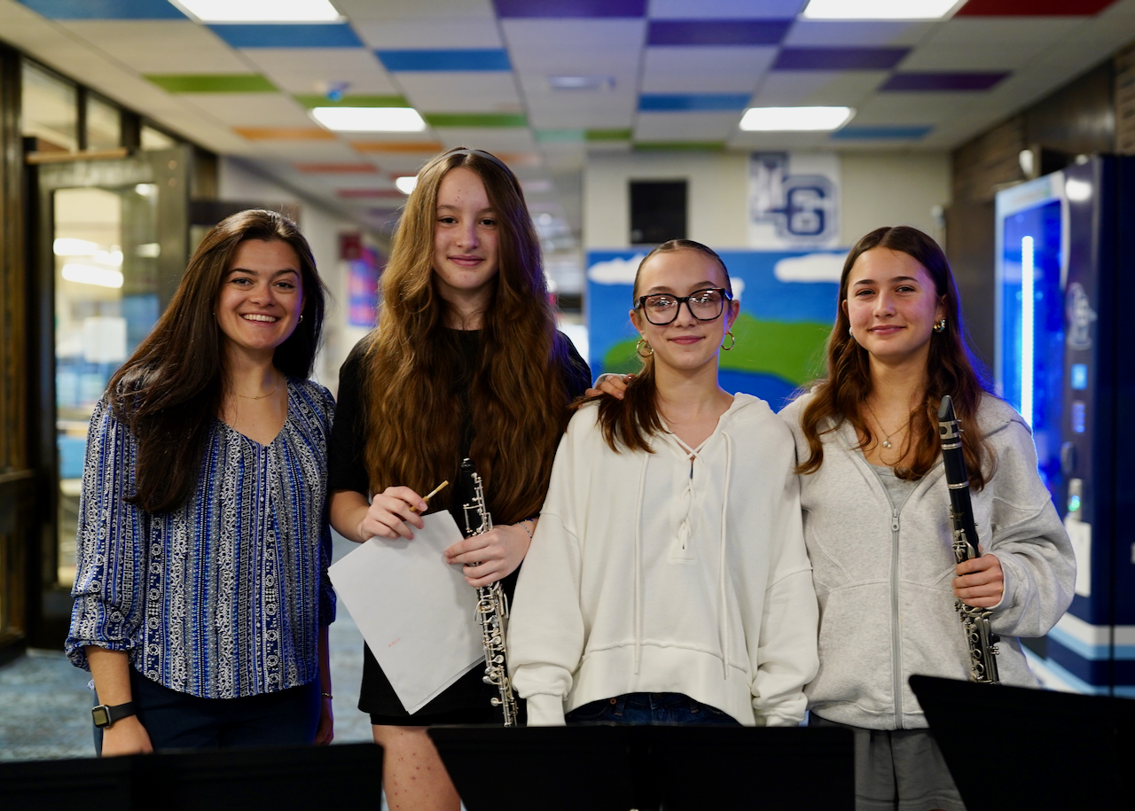 Former teacher sits with senior at picnic table