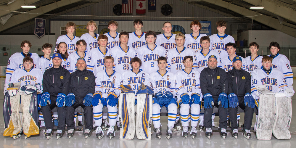 Hockey team sitting and standing for photo