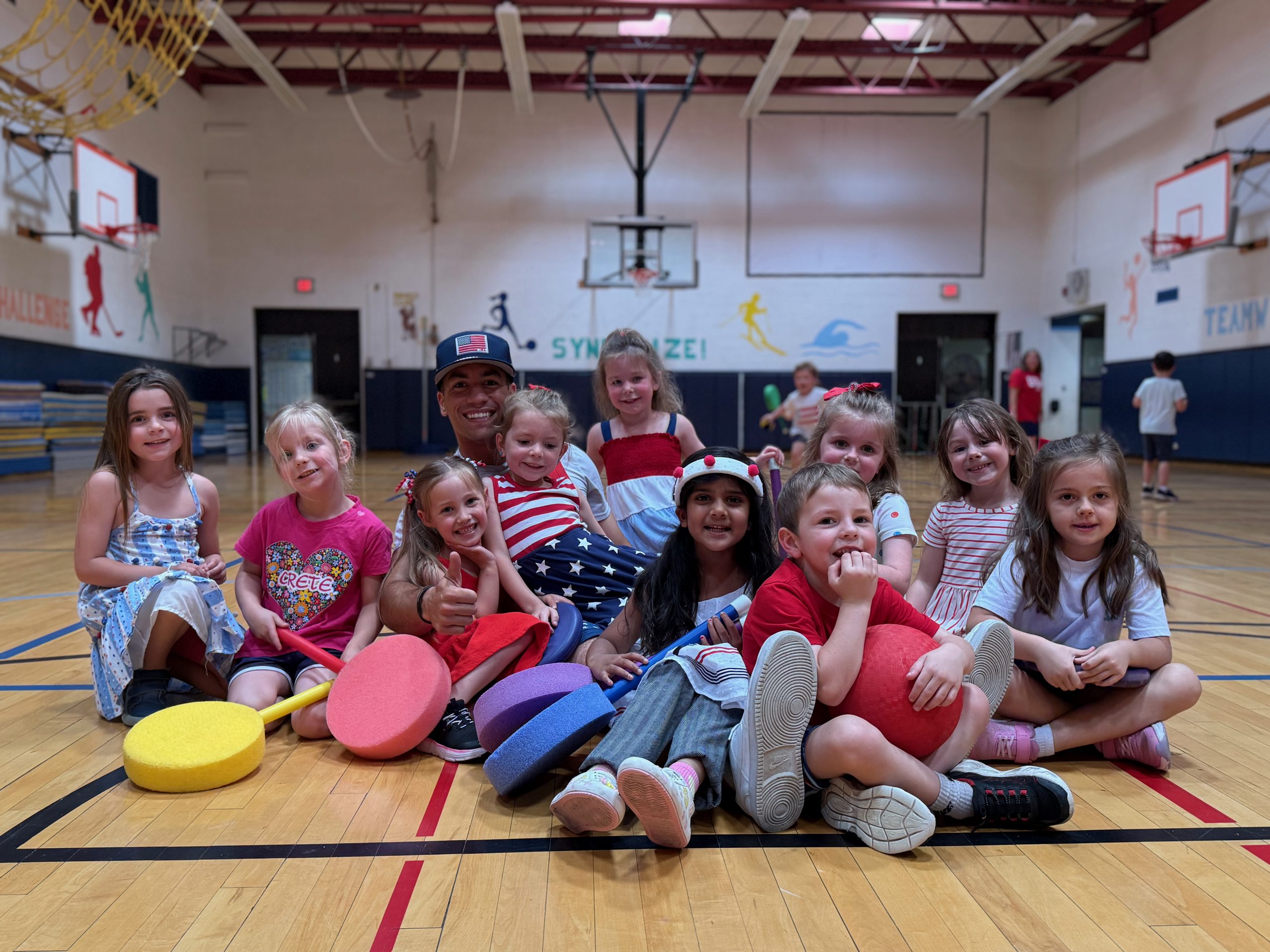 Students sitting on floor of classroom