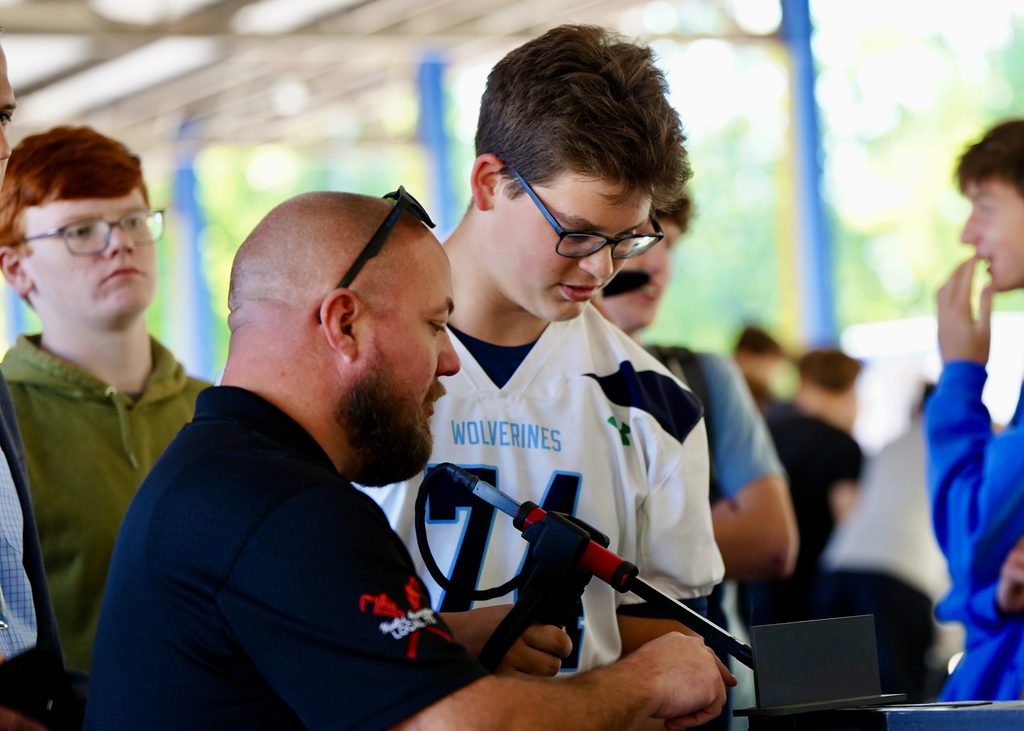 Adults and student practice welding